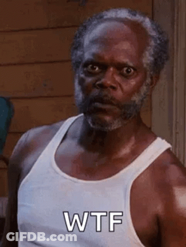 A Man With A Beard Is Wearing A White Tank Top . GIF