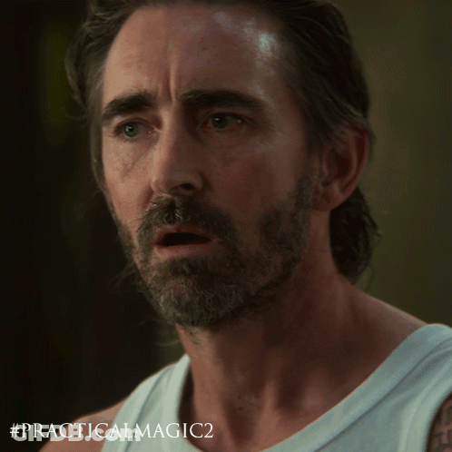 A Man With A Beard Is Wearing A White Tank Top With # Practicalmagic2 Written On It GIF