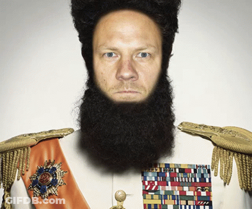 A Man With A Beard Is Wearing A White Uniform With Gold Shoulder Pads GIF