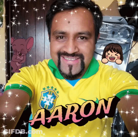 A Man With A Beard Is Wearing A Yellow Shirt That Says Aaron On It GIF