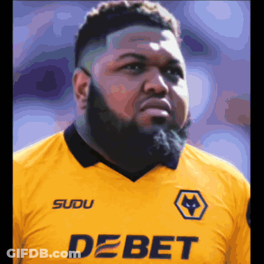 A Man With A Beard Is Wearing A Yellow Shirt That Says Debet On It GIF