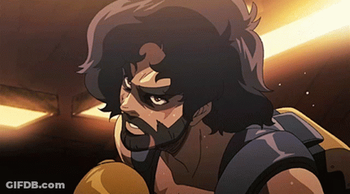 A Man With A Beard Is Wearing Boxing Gloves In A Dark Room GIF