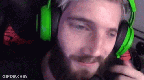 A Man With A Beard Is Wearing Green Headphones And A Microphone . GIF