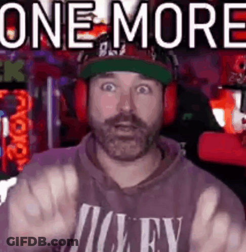 A Man With A Beard Is Wearing Headphones And A Hat And Giving The Middle Finger . GIF