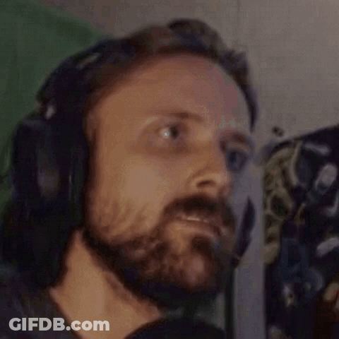 A Man With A Beard Is Wearing Headphones And A Headset . GIF