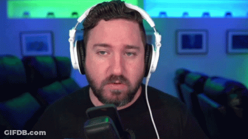 A Man With A Beard Is Wearing Headphones And A Microphone GIF