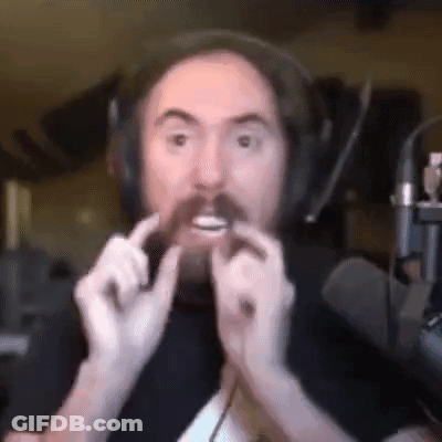 A Man With A Beard Is Wearing Headphones And Holding A Piece Of Bread In His Mouth . GIF