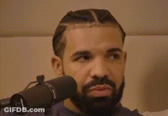 A Man With A Beard Is Wearing Headphones And Looking At The Camera . GIF