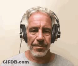 A Man With A Beard Is Wearing Headphones And Making A Funny Face . GIF