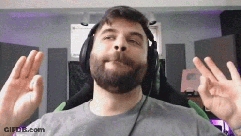 A Man With A Beard Is Wearing Headphones And Making An Ok Sign GIF