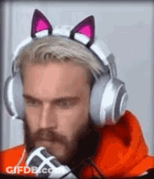 A Man With A Beard Is Wearing Headphones With Cat Ears On His Head . GIF