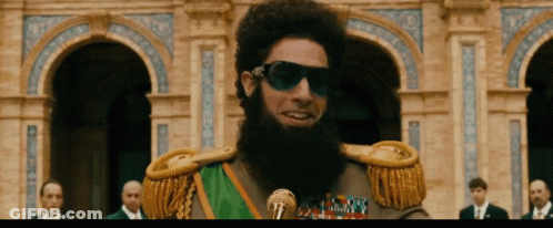 Bearded Man Wearing Sunglasses And Green Sash GIF