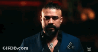 A Man With A Beard Is Wearing Sunglasses And A Ring And The Word Andrade Is Behind Him GIF