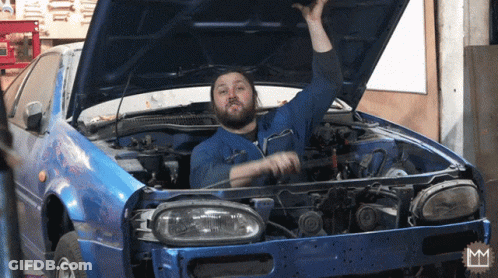 A Man With A Beard Is Working On A Blue Car GIF