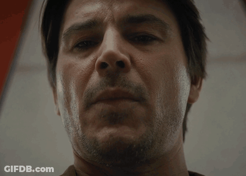 A Man With A Beard Looks At The Camera With A Serious Look On His Face GIF