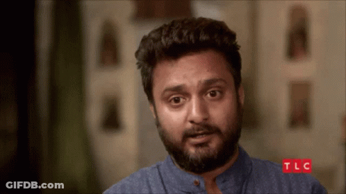 A Man With A Beard Looks At The Camera With Tlc Written On The Bottom GIF