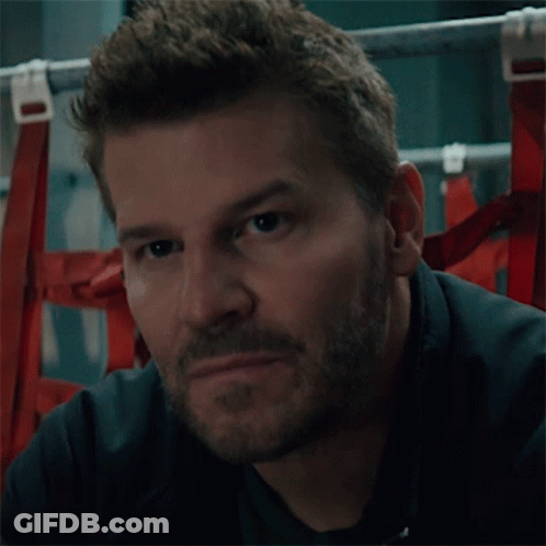 A Man With A Beard Looks At The Camera GIF