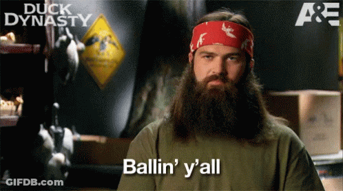 A Man With A Beard Says Ballin ' Y 'All In Front Of A Sign That Says Duck Dynasty GIF