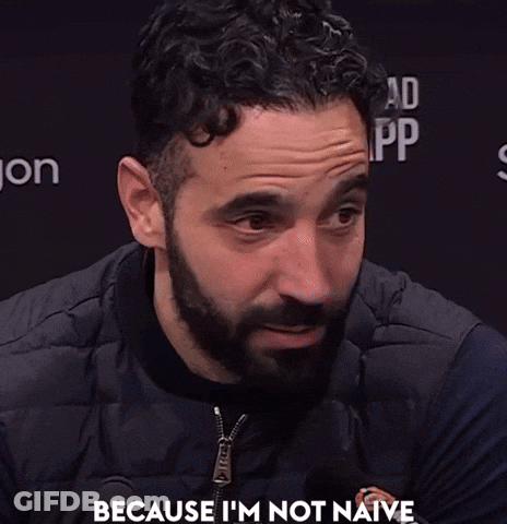 A Man With A Beard Says " Because I 'M Not Naive " In Front Of A Black Background GIF