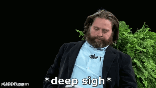 A Man With A Beard Says " Deep Sigh " In Front Of Some Ferns GIF