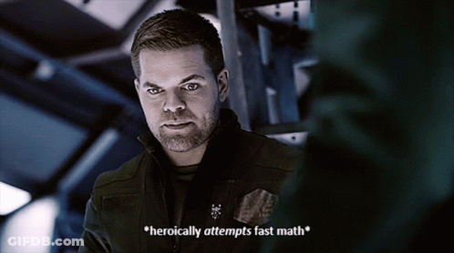 A Man With A Beard Says " Heroically Attempts Fast Math " In A Dark Room GIF