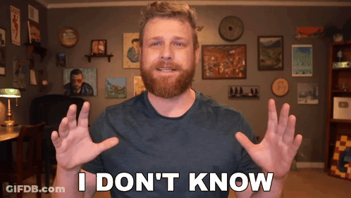 A Man With A Beard Says " I Don 'T Know " In Front Of A Wall Of Pictures GIF