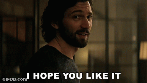A Man With A Beard Says " I Hope You Like It " In Front Of Him GIF