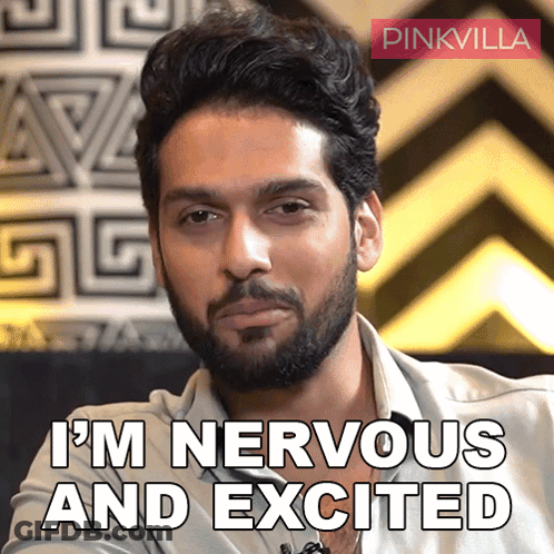 A Man With A Beard Says " I 'M Nervous And Excited " In Front Of A Pinkvilla Logo GIF