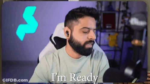 A Man With A Beard Says I 'M Ready While Sitting In Front Of A Microphone GIF