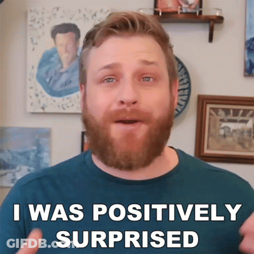 A Man With A Beard Says " I Was Positively Surprised " In Front Of Paintings GIF