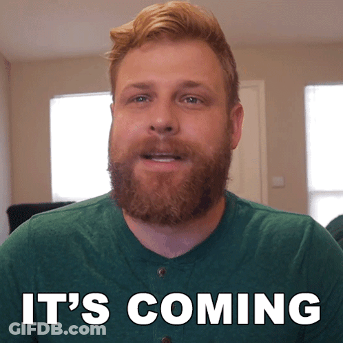 A Man With A Beard Says It 'S Coming In White Letters GIF