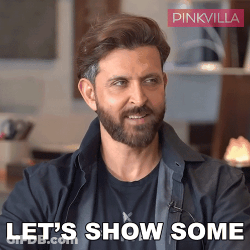 A Man With A Beard Says " Let 'S Show Some " In Front Of A Pinkvilla Logo GIF