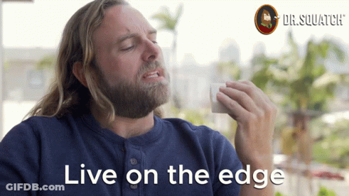 A Man With A Beard Says " Live On The Edge " In Front Of A Dr.squatch Logo GIF