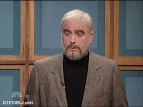 A Man With A Beard Says " Moo " While Standing In Front Of A Wooden Wall GIF