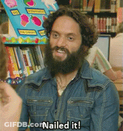 A Man With A Beard Says Nailed It In Front Of A Bookshelf GIF