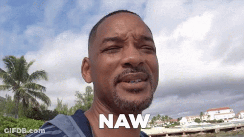 A Man With A Beard Says Naw In Front Of A Beach GIF