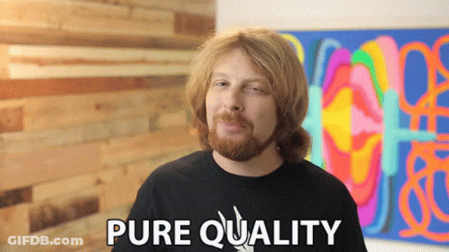A Man With A Beard Says Pure Quality In Front Of A Painting GIF