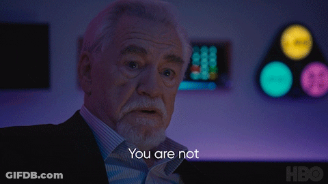 A Man With A Beard Says Serious People In Front Of A Purple Background GIF