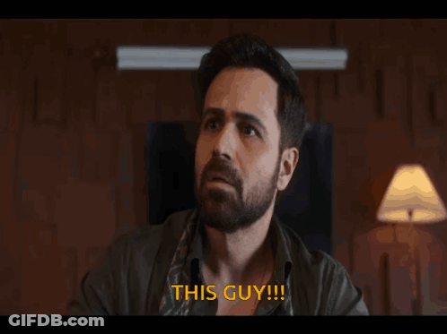 A Man With A Beard Says " This Guy " In Orange Letters GIF