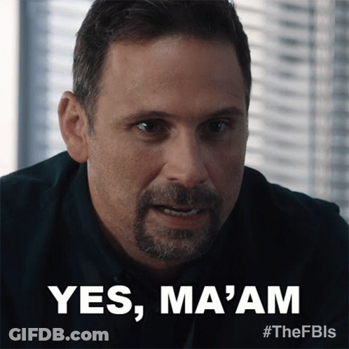 A Man With A Beard Says " Yes Ma 'Am " In Front Of A Window GIF