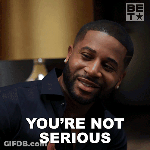 A Man With A Beard Says You 'Re Not Serious In Front Of A Lamp GIF