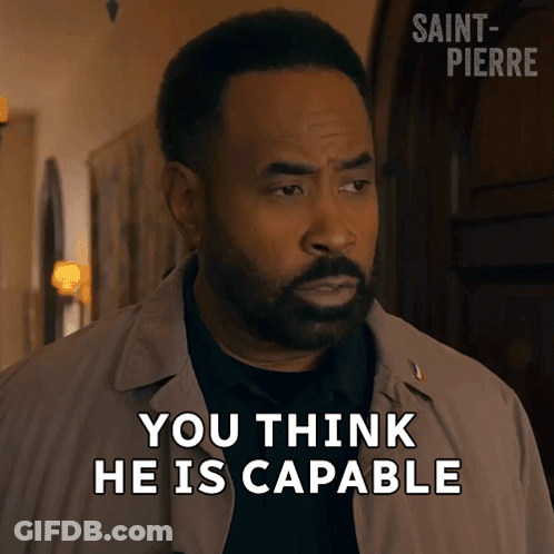 A Man With A Beard Says " You Think He Is Capable " In Front Of A Door GIF