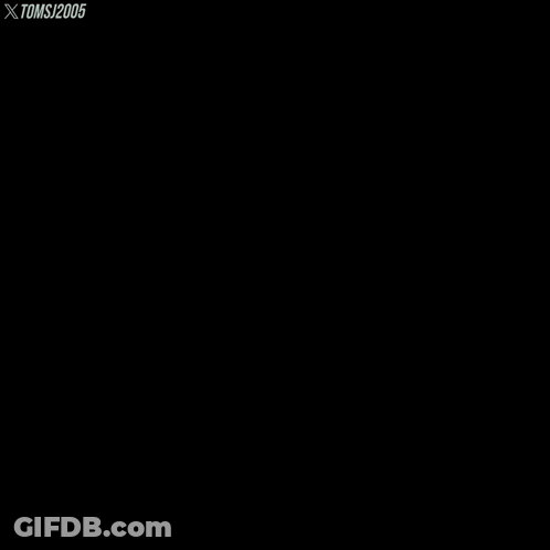 A Man With A Beard Sits In A Grassy Field With Toms 2005 Written On The Bottom Right GIF