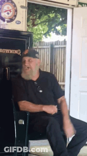 A Man With A Beard Sits In Front Of A Browning Safe GIF