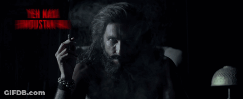A Man With A Beard Smoking A Cigarette With The Words Yeh Naya Hindustan Hai In Red Letters GIF