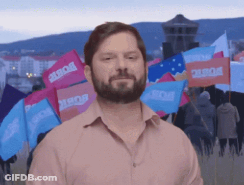 A Man With A Beard Stands In Front Of A Bunch Of Flags That Say Bob GIF