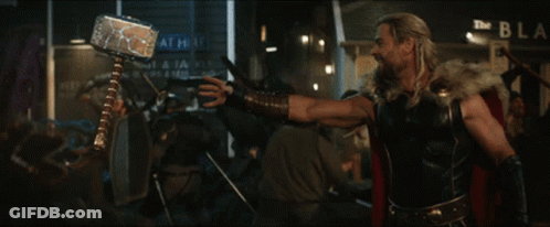 A Man With A Beard Stands In Front Of A Crowd Of People GIF