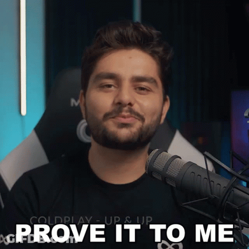 A Man With A Beard Stands In Front Of A Microphone And Says " Prove It To Me " GIF