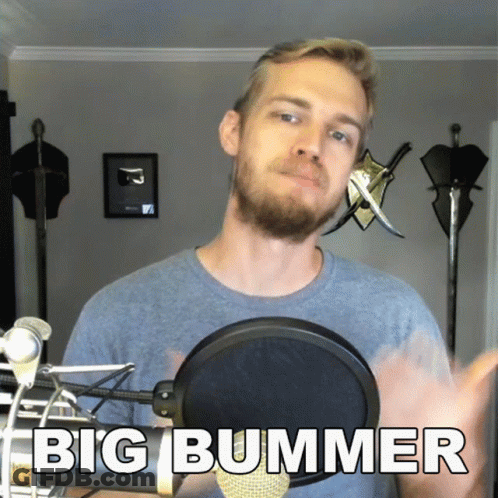 A Man With A Beard Stands In Front Of A Microphone With The Words Big Bummer Below Him GIF