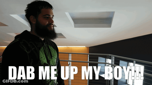 A Man With A Beard Stands In Front Of A Sign That Says " Dab Me Up My Boy " GIF